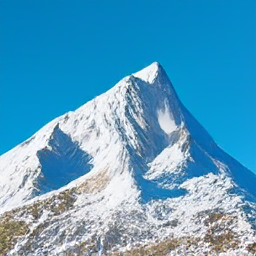 A snowy mountain peak with blue sky