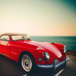 A vintage red sports car parked on a coastal highway at sunset